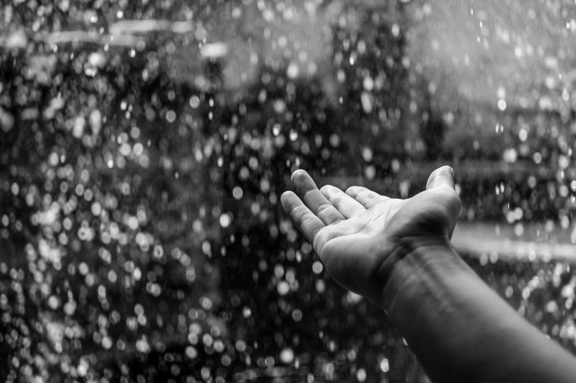 black and white hand raining